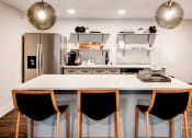 Thumbnail 1 of 28 - a kitchen with a large center island with a white countertop at Hamilton at Kings Place, Maryland, 21046