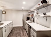Thumbnail 2 of 28 - a kitchen with white countertops and stainless steel appliances at Hamilton at Kings Place, Maryland