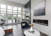 Thumbnail 25 of 35 - a living room with a blue chair and a white coffee table at Madison at Eden Brook, Columbia
