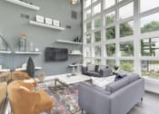 Thumbnail 26 of 35 - a living room with a large wall of windows at Madison at Eden Brook, Columbia Maryland