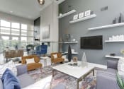 Thumbnail 30 of 35 - a living room with gray walls and a white coffee table at Madison at Eden Brook, Columbia, MD