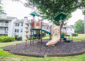 Thumbnail 27 of 28 - a playground with a slide and climbing equipment in front of an apartment building at Hamilton at Kings Place, Columbia, 21046