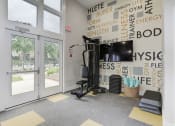 Thumbnail 33 of 35 - a gym with a treadmill and a tv on the wall at Madison at Eden Brook, Maryland, 21046