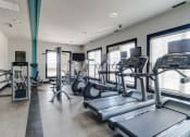 Thumbnail 26 of 33 - a gym with treadmills and other exercise equipment  at Ellicott Grove, Ellicott City, MD 21043