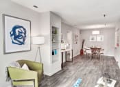 Thumbnail 9 of 28 - a living room with a couch and chair and a dining room table in the background at Hamilton at Kings Place, Maryland, 21046
