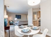 Thumbnail 13 of 33 - a dining area with a table and chairs and a kitchen in the background at Ellicott Grove, Ellicott City, 21043