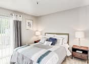 Thumbnail 13 of 28 - a bedroom with a bed and two night stands with lamps at Hamilton at Kings Place, Columbia Maryland