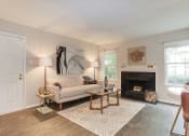 Thumbnail 18 of 35 - a living room with a fireplace and a couch at Madison at Eden Brook, Columbia, 21046