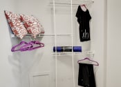 Thumbnail 15 of 28 - a rack for clothes and shoes hangs on the wall in a small room at Hamilton at Kings Place, Columbia, MD