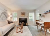 Thumbnail 15 of 35 - a living room with a couch table and chairs and a fireplace at Madison at Eden Brook, Maryland, 21046