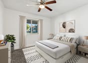 Thumbnail 4 of 33 - A bedroom with a large bed, a ceiling fan, and a window with curtains at Riviera Park, Chandler Arizona