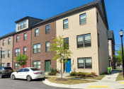 Thumbnail 30 of 30 - a brick apartment building with cars parked in front of it at Refinery Row, Baltimore, MD 21224