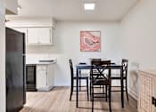 Thumbnail 10 of 33 - A kitchen with a table and chairs and a fridge.at Riviera Park, Chandler, AZ 85224