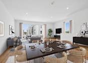 Thumbnail 3 of 8 - A modern dining room with a large table set for six.