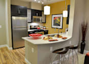 Thumbnail 44 of 84 - Fitted Kitchen With Island Dining at Mira Upper Rock, Rockville, 20850