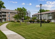 Thumbnail 20 of 40 - Spacious courtyard with walking path and lamppost at The Brook At Columbia Apartments, Columbia