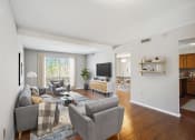 Thumbnail 6 of 54 - a living room with couches and chairs and a tv at Villages at Morgan Metro, Landover