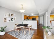 Thumbnail 7 of 54 - a dining room with a table and chairs and a kitchen at Villages at Morgan Metro, Maryland