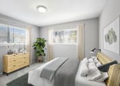 Thumbnail 11 of 54 - a bedroom with a bed and a dresser and two windows at Villages at Morgan Metro, Landover, 20785
