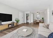 Thumbnail 5 of 45 - A living room with a white couch and a flat screen TV at Poplar Glen Apartments, Columbia, MD, 21044.