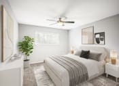 Thumbnail 10 of 54 - a bedroom with a bed and a ceiling fan at Villages at Morgan Metro, Landover, Maryland