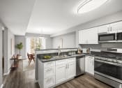 Thumbnail 4 of 54 - a renovated kitchen with white cabinets and stainless steel appliances at Villages at Morgan Metro, Landover, MD