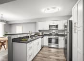 Thumbnail 3 of 54 - a renovated kitchen with white cabinets and stainless steel appliances at Villages at Morgan Metro, Landover, MD