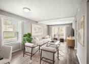 Thumbnail 9 of 54 - a living room with a white couch and chairs at Villages at Morgan Metro, Landover, 20785