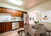 Thumbnail 3 of 24 - Kitchen with dining area at Poplar Glen Apartments, Maryland.