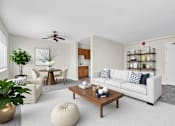 Thumbnail 5 of 24 - A living room with a white couch, a coffee table, and a ceiling fan at Highland Ridge Apartments, Capitol Heights, MD, 20743