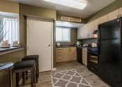 Thumbnail 20 of 27 - a kitchen with black appliances and a black refrigerator at Meadows at Capitol Heights, Capitol Heights