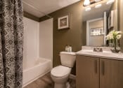 Thumbnail 23 of 27 - Bathroom with a toilet, sink and a tub at Meadows at Capitol Heights, Maryland, 20743