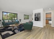 Thumbnail 2 of 6 - a living room with a couch and a chair at Earle Manor Apartments, Wheaton, Maryland