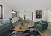 Thumbnail 1 of 6 - a living room with two green couches and a table with a chair at Earle Manor Apartments, Maryland, 20902