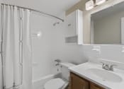 Thumbnail 5 of 6 - a white bathroom with a shower sink and toilet at Earle Manor Apartments, Wheaton, MD 20902