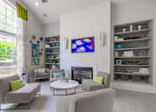 Thumbnail 30 of 48 - A living room with a fireplace, a television, and a couch at Ellicott Grove, Ellicott City, MD 21043