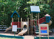 Thumbnail 40 of 48 - A playground with a slide, a treehouse, and a sign that says at Ellicott Grove, Ellicott City, MD 21043