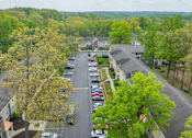 Thumbnail 43 of 48 - A parking lot with cars and trees in the background at Ellicott Grove, Ellicott City, MD 21043