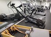 Thumbnail 7 of 8 - A gym with treadmills, elliptical machines and other cardio equipment.