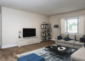 Thumbnail 2 of 18 - a living room with a couch and a tv at Hamilton Manor Apartments, Maryland