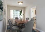 Thumbnail 4 of 18 - a dining room with a wooden table and chairs at Hamilton Manor Apartments, Hyattsville, MD 20782