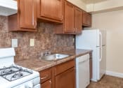 Thumbnail 6 of 18 - a kitchen with a sink and a stove and a refrigerator at Hamilton Manor Apartments, Maryland, 20782