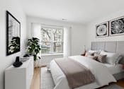 Thumbnail 5 of 18 - Modern bedroom with neutral tones and large window at Park at Winterset Apartments, Owings Mills