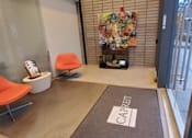 Thumbnail 5 of 8 - A waiting area with chairs and a sign that says "CABIN".