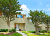 Thumbnail 48 of 54 - a yellow house with trees in front of it at Villages at Morgan Metro, Landover, MD 20785