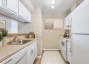 Thumbnail 4 of 35 - a kitchen with white appliances and white cabinets at Madison at Eden Brook, Columbia