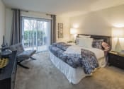 Thumbnail 19 of 35 - a bedroom with a bed and a desk with a chair at Madison at Eden Brook, Columbia Maryland