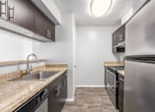 Thumbnail 14 of 56 - A kitchen with a sink, stove, and refrigerator at Madison at Eden Brook, 21046