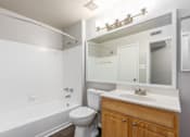 Thumbnail 27 of 56 - A white bathroom with a toilet, sink, and bathtub at Madison at Eden Brook, 21046