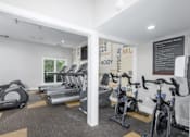 Thumbnail 49 of 56 - A gym with treadmills, exercise bikes, and a sign that says at Madison at Eden Brook, 21046